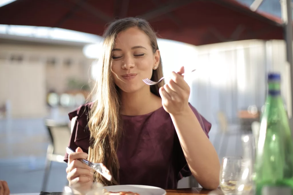 Woman in Purple Eating in a public place. 