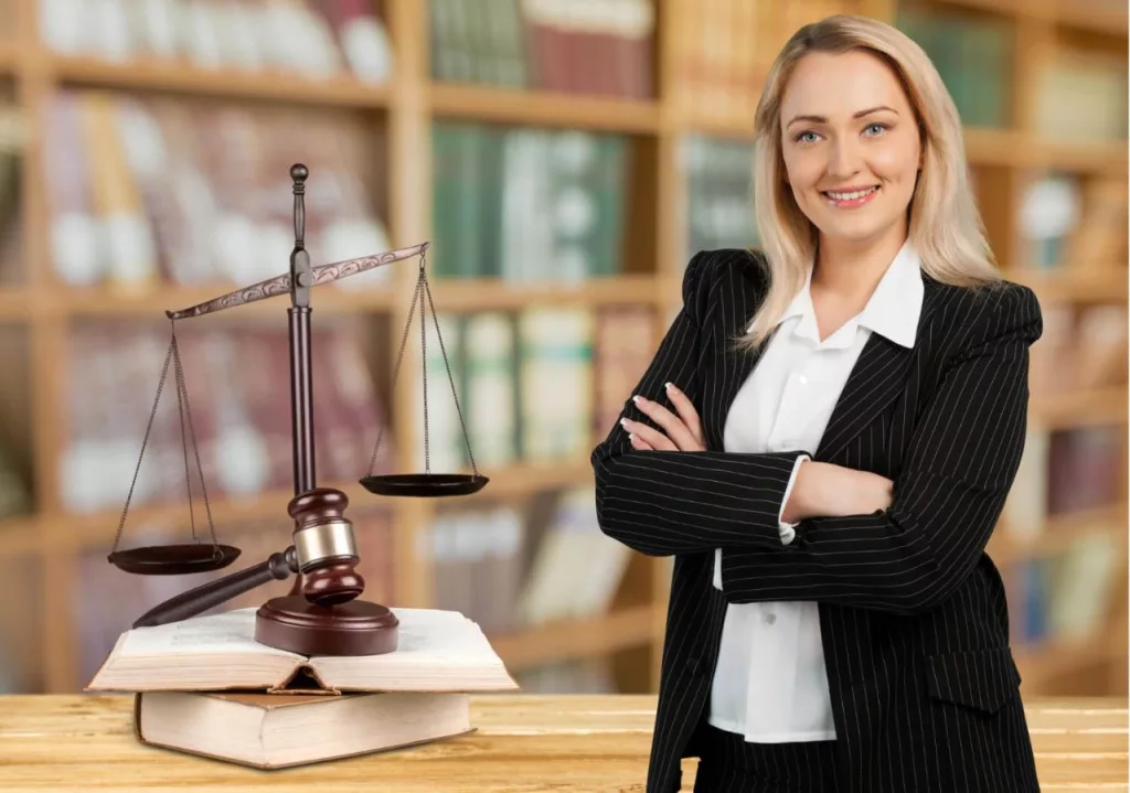 A woman wearing white shirt and black coat posing in the court room.