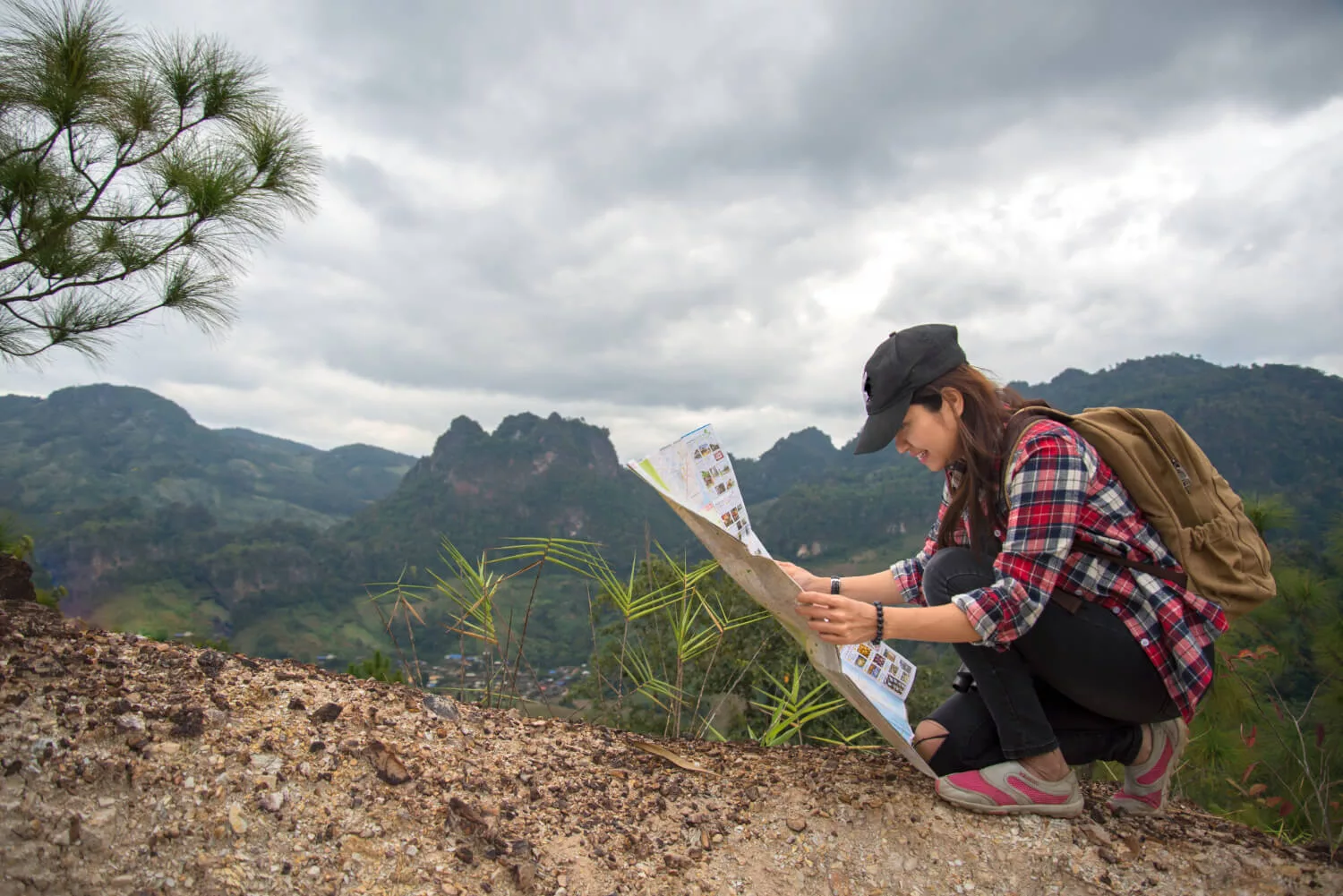 women-traveler-with-backpack-checks-map-find-directions-wilderness-area