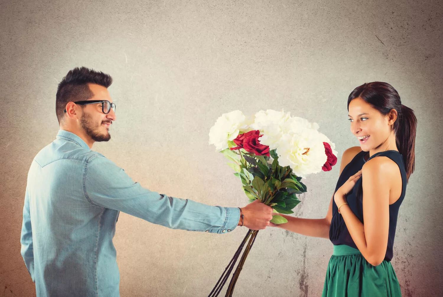 young-couple-standing-against-blue-wall