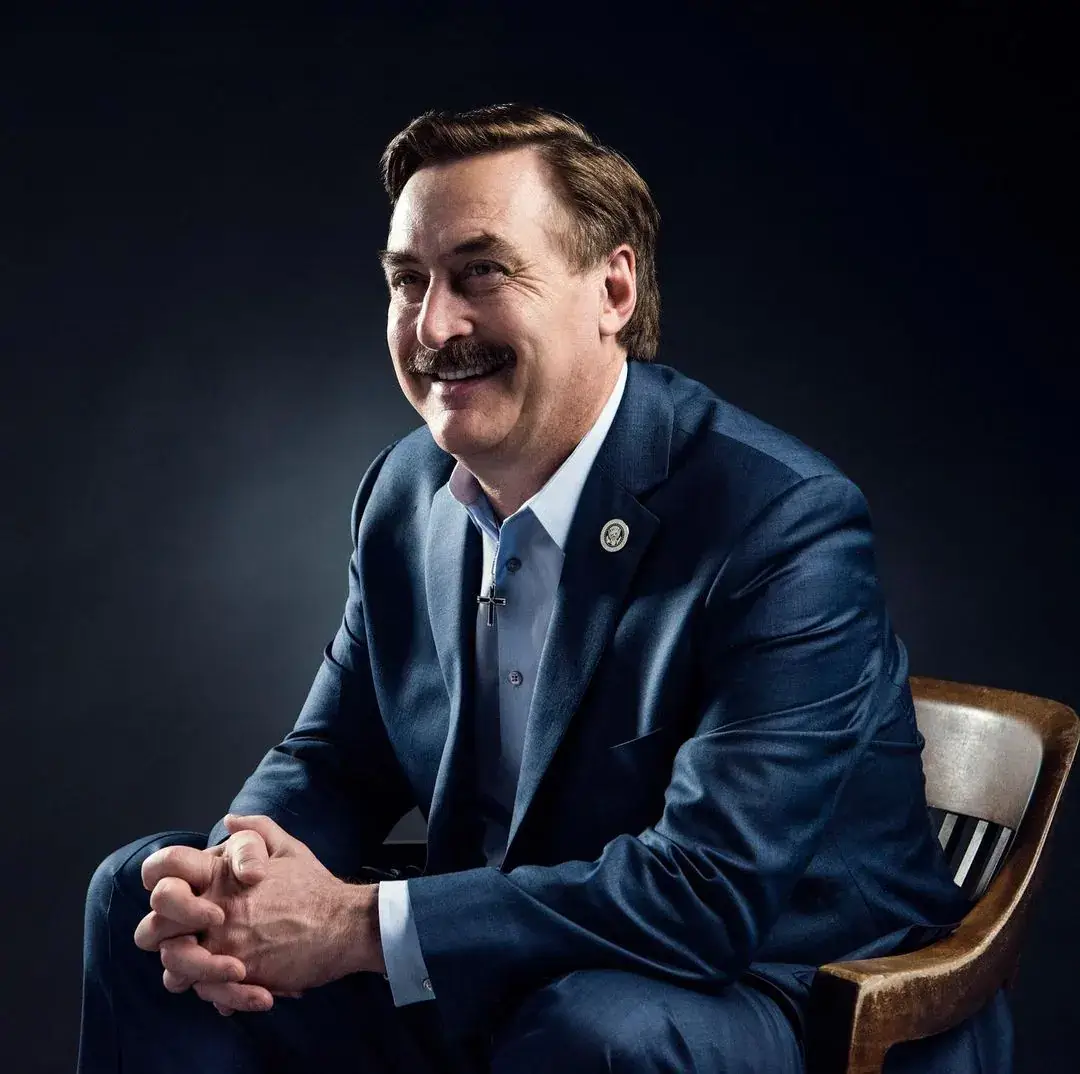 mike lindell in coat sitting