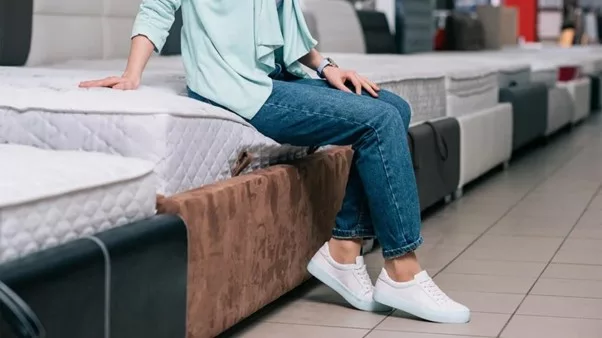 a boy sitting on mattress