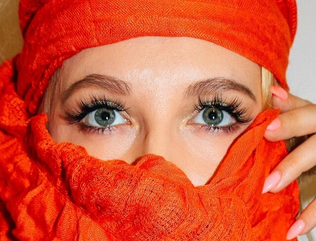 girl face covered in red scarf