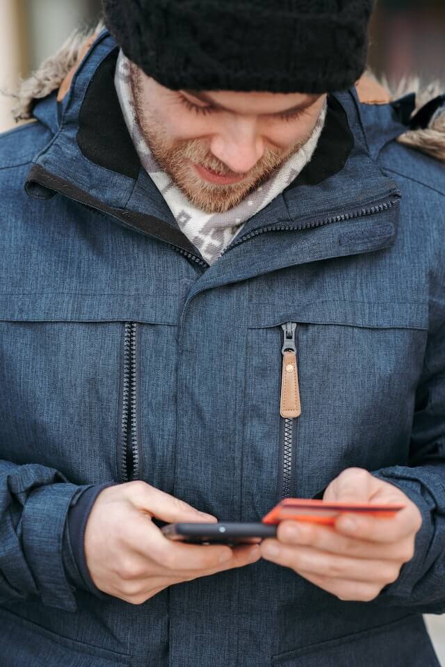 boy in blue shirt using card