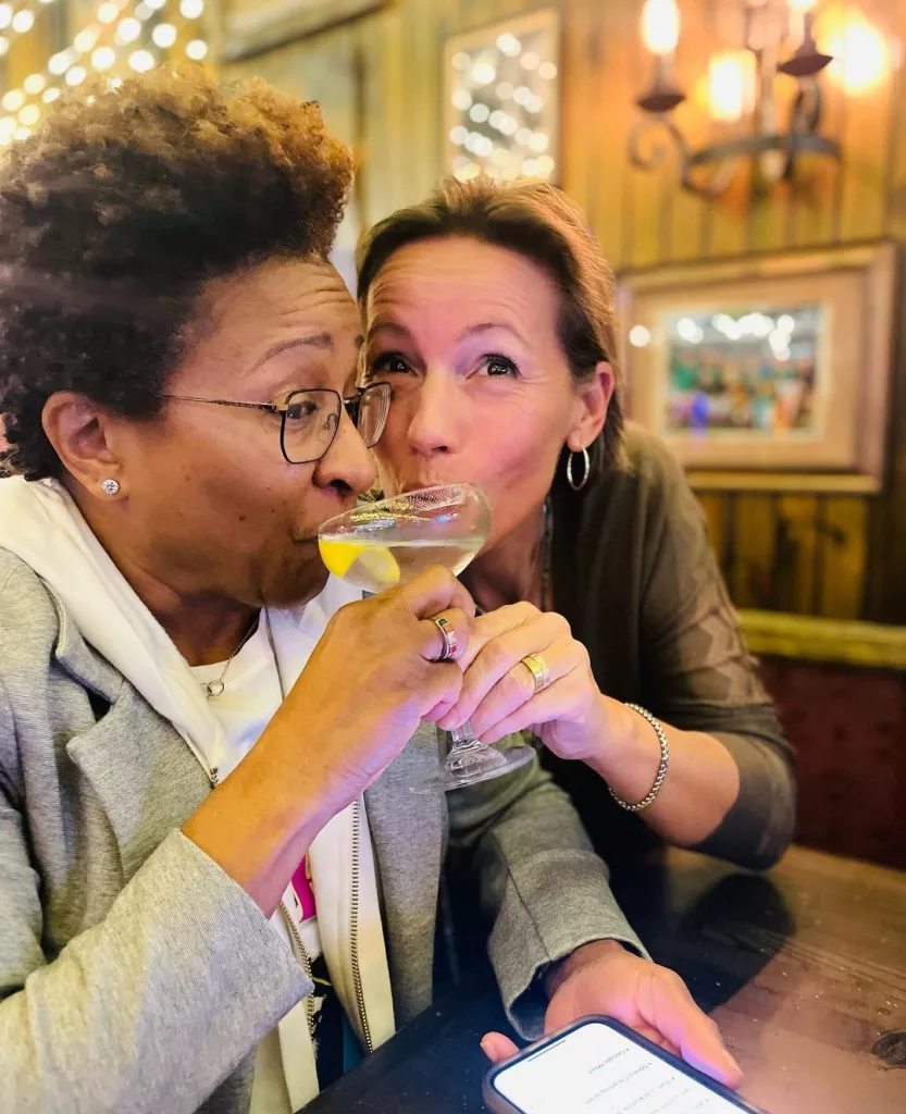 Wanda and Alex drinking juice from the same glass.