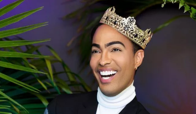 Pollito Tropical wearing a crown and black coat.