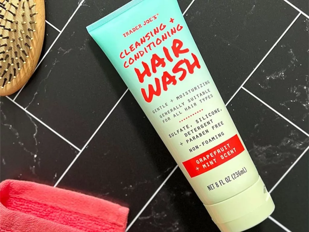 Trader Joe's hair wash on table with hair brush