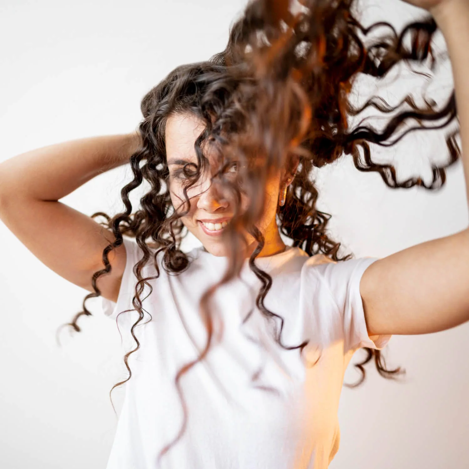 girl playing with curly hair