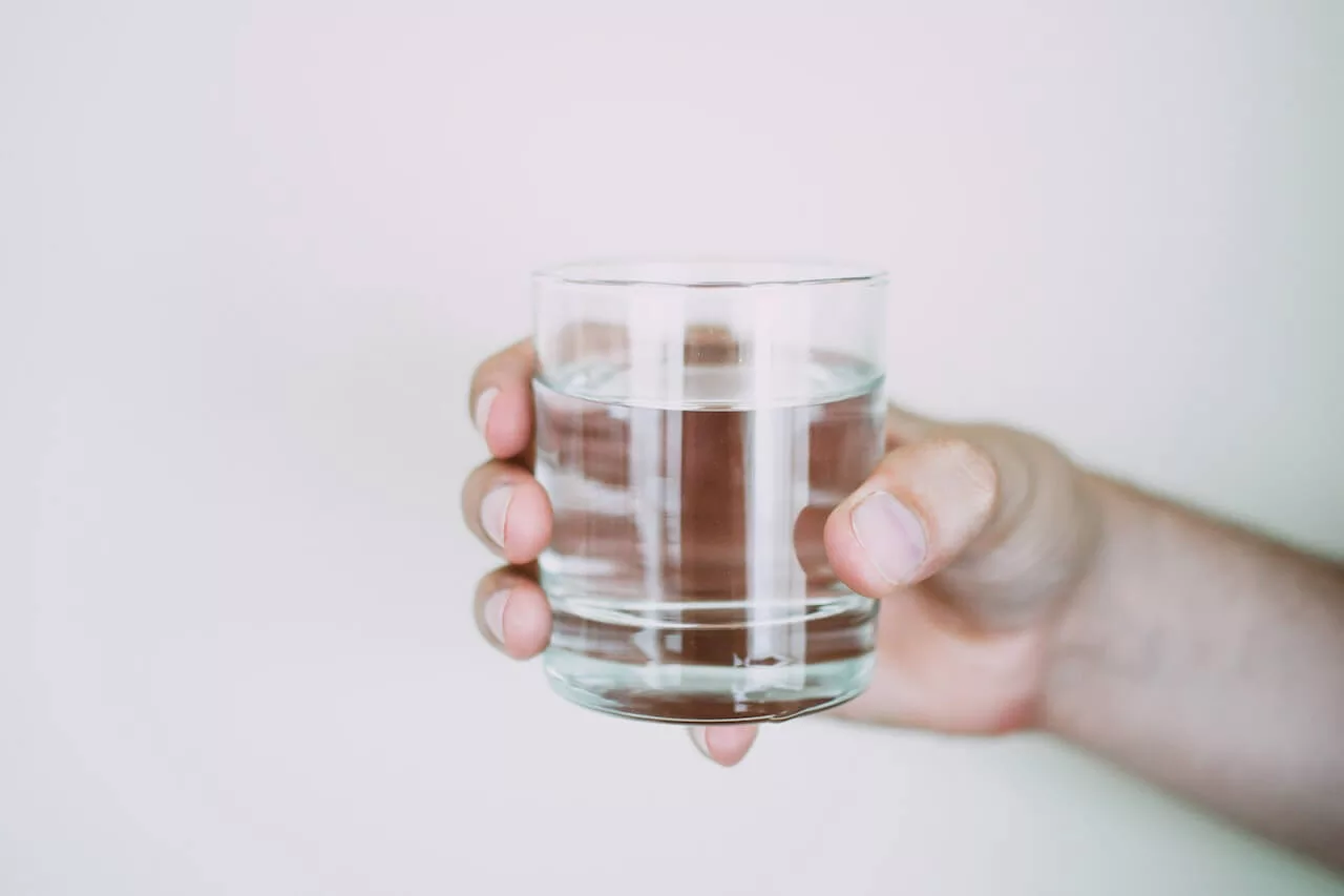 man holding glass of water