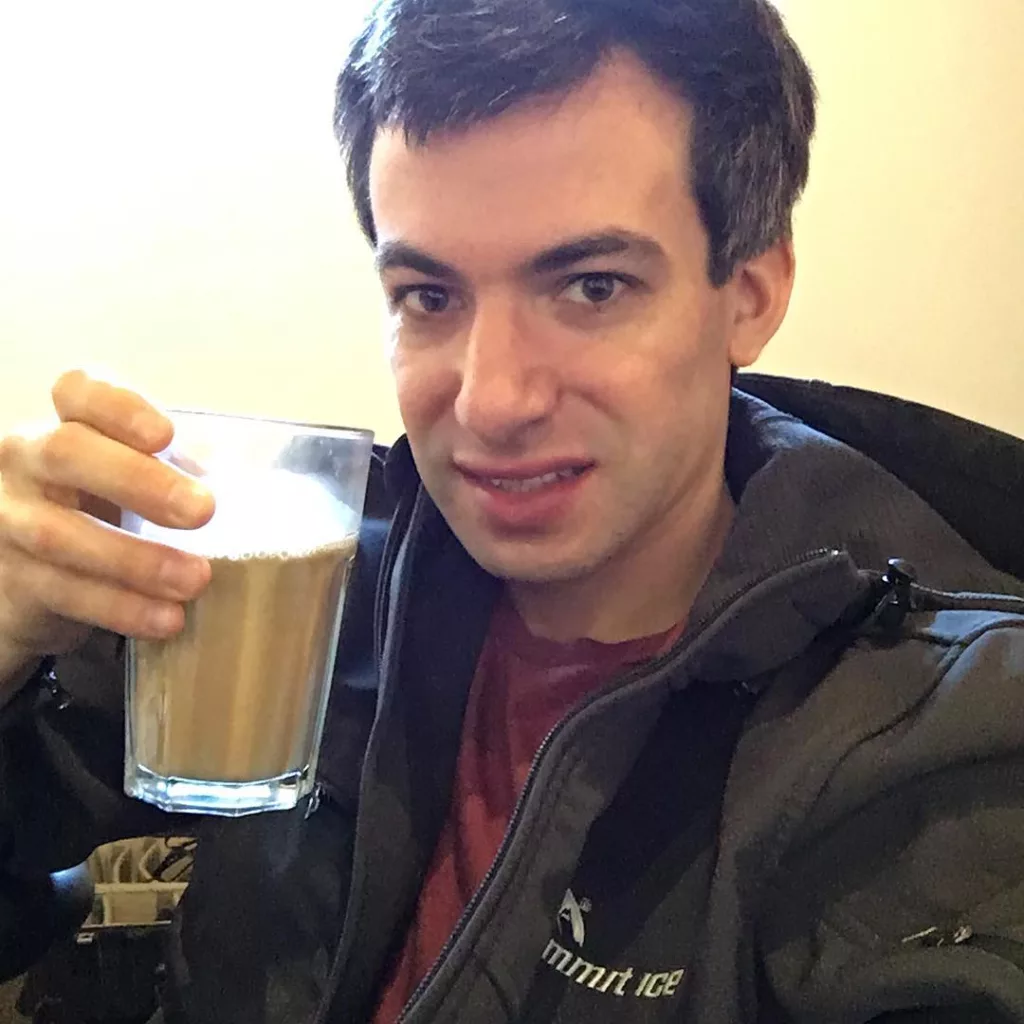 Nathan Fielder drinking coffee and taking selfie