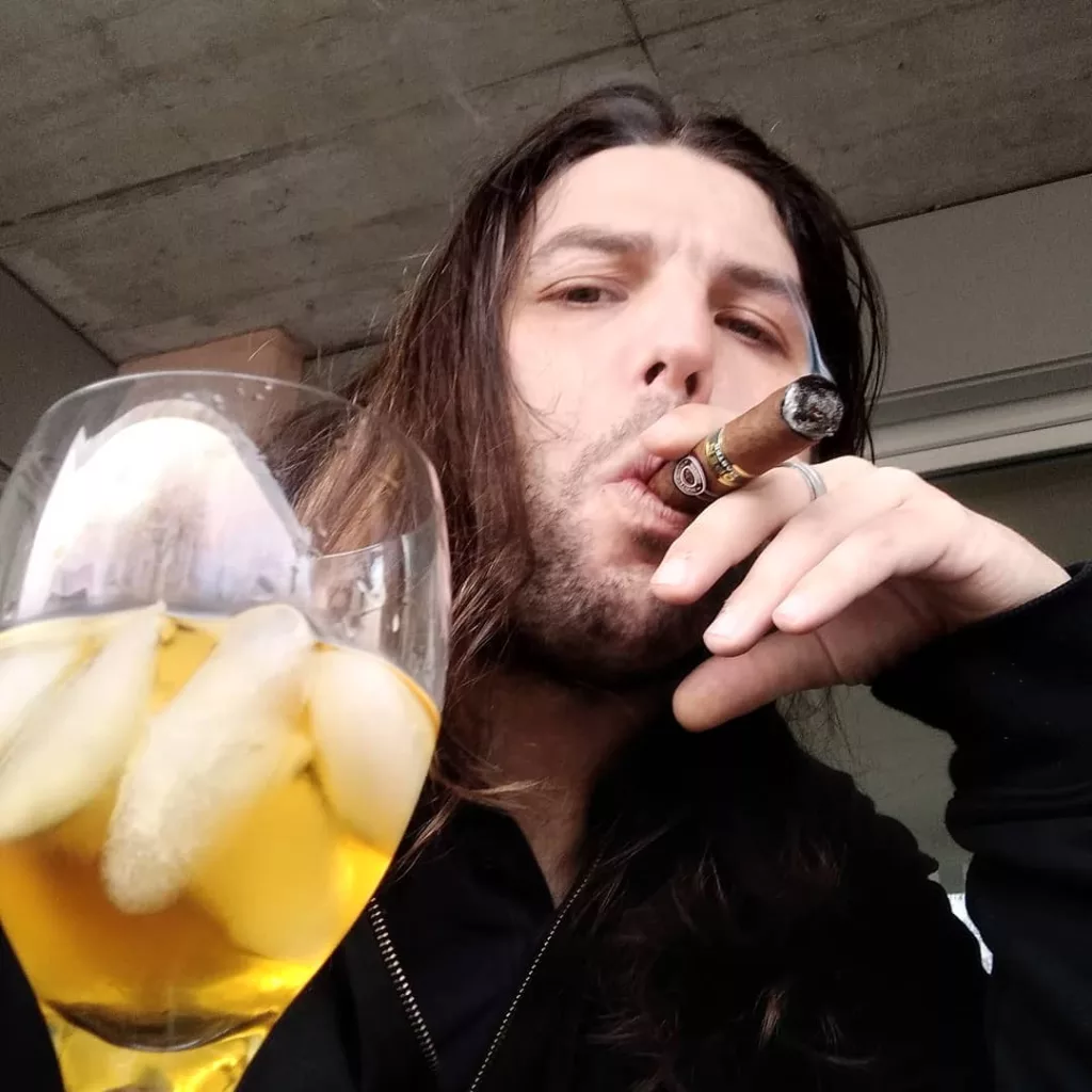 Navarone taking selfie while drinking wine and smoking 