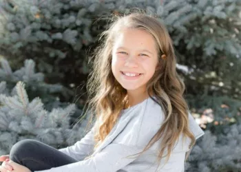 Weslie Fowler wearing white top and smiling.