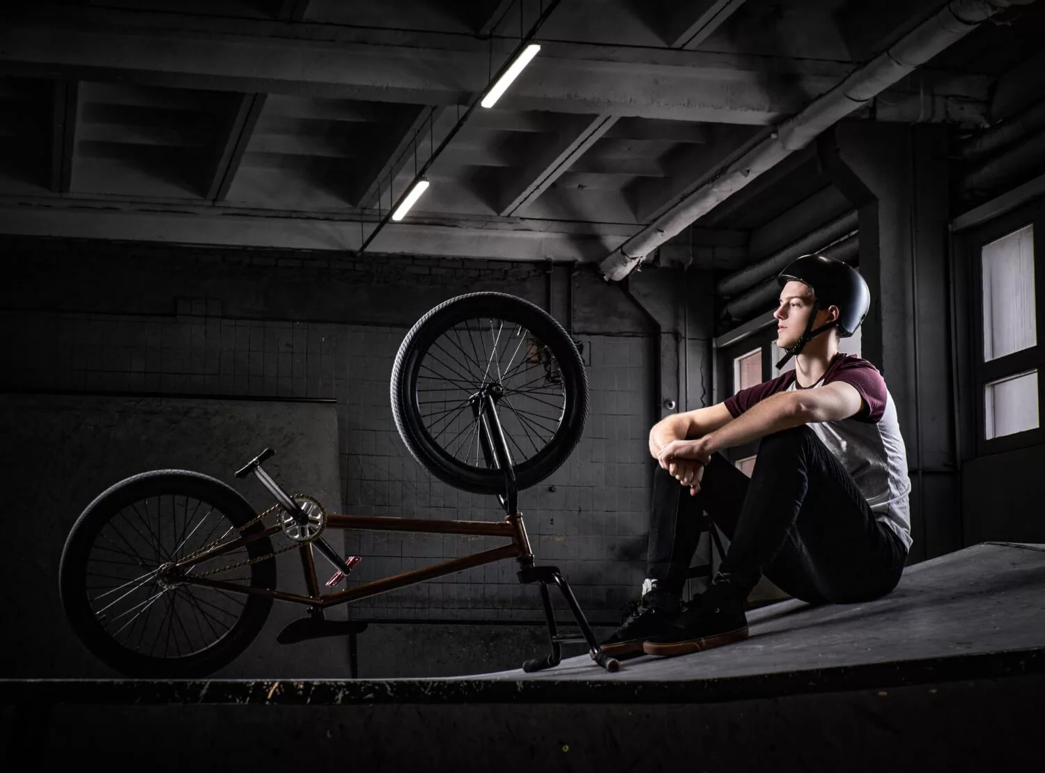 biker sitting beside his bike