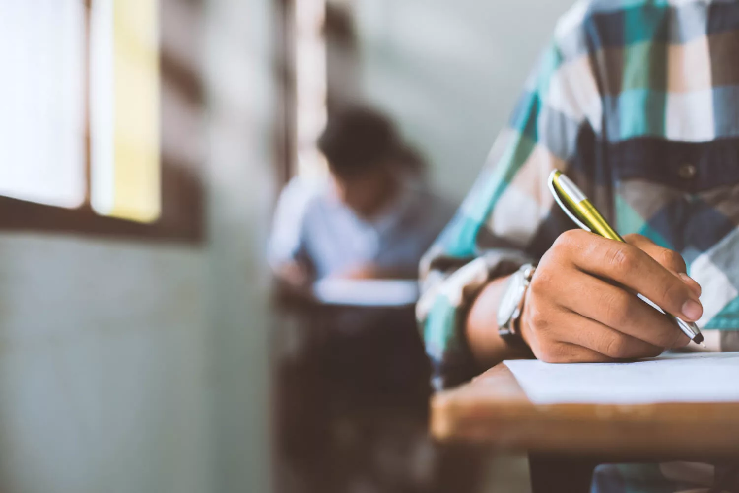 boy writing exam