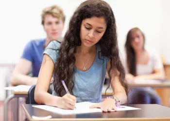 girl in blue giving exam