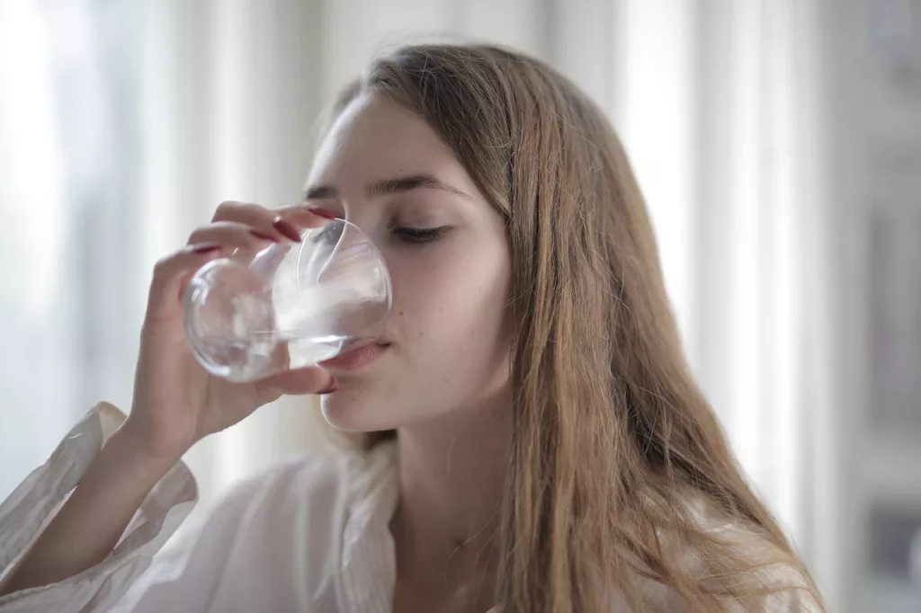 Woman Drinking Water from a glass.