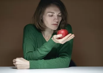 Woman Holding Red Apple