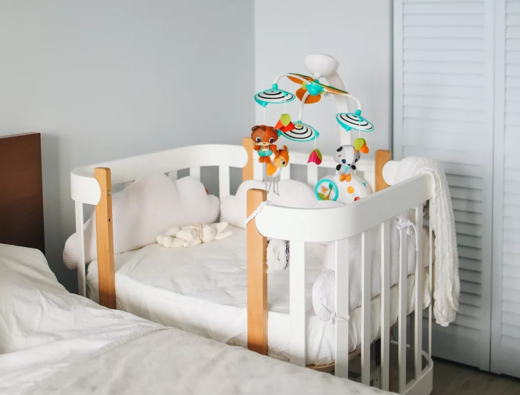 White crib in bright bedroom