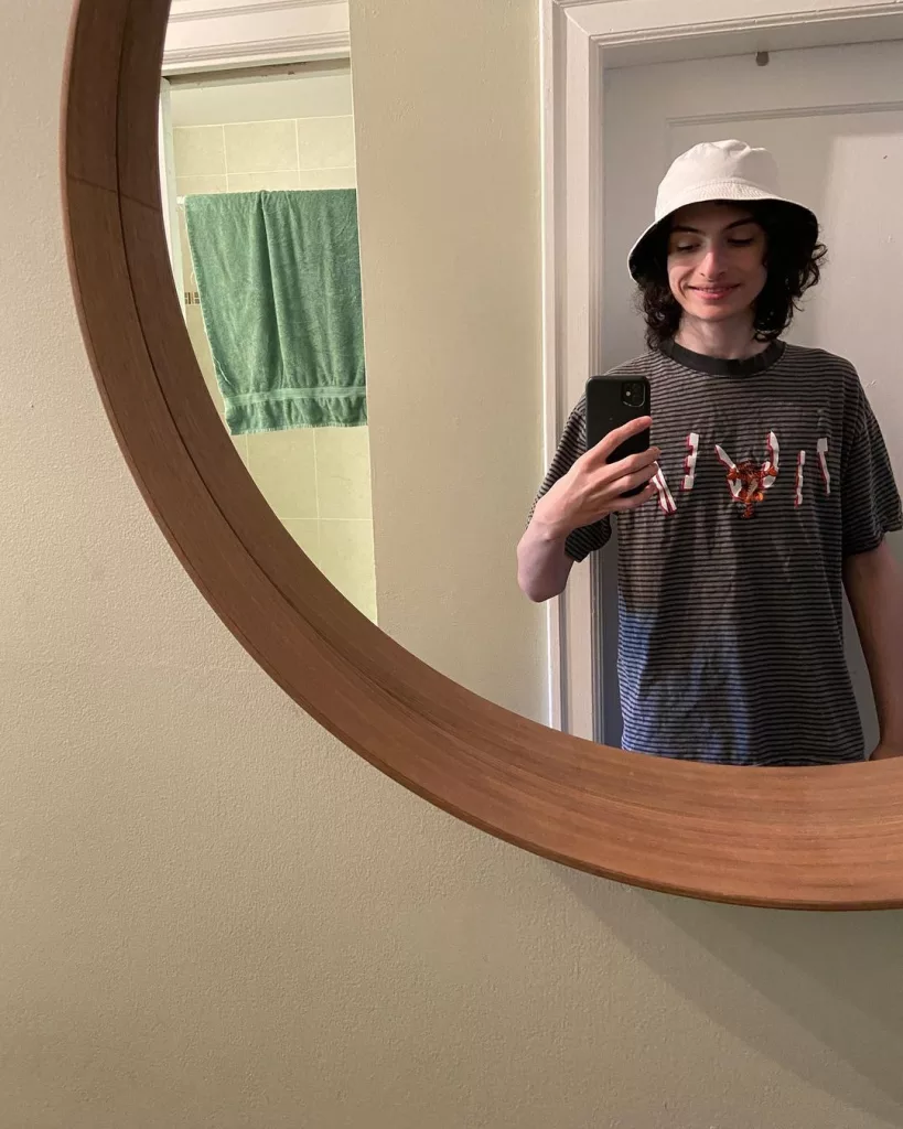 Finn Wolfhard taking mirror selfie.