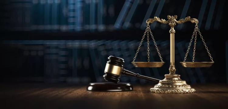 legal books and gavel along with the scales of Justice on the table