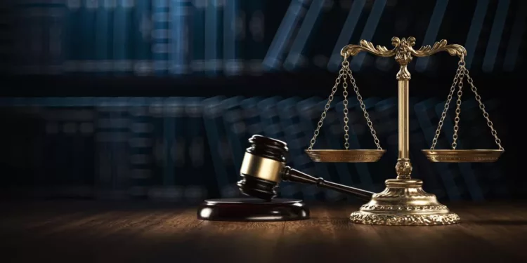 legal books and gavel along with the scales of Justice on the table