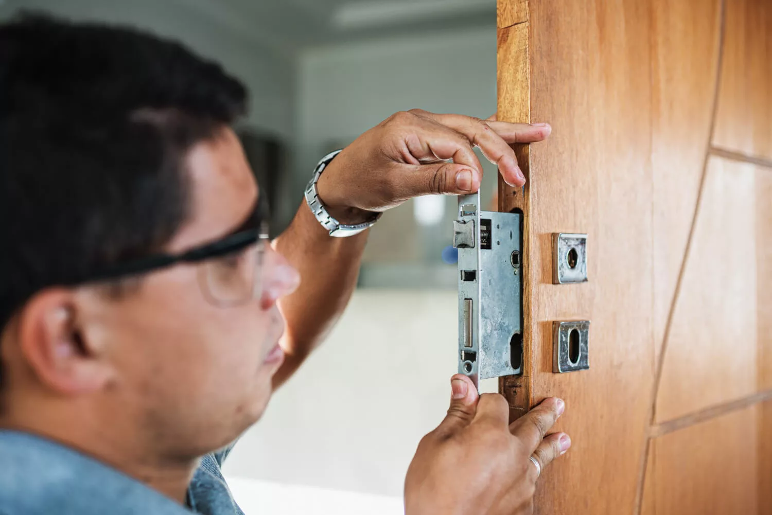 close-up-male-hands-repair-installing-metal-door-lock