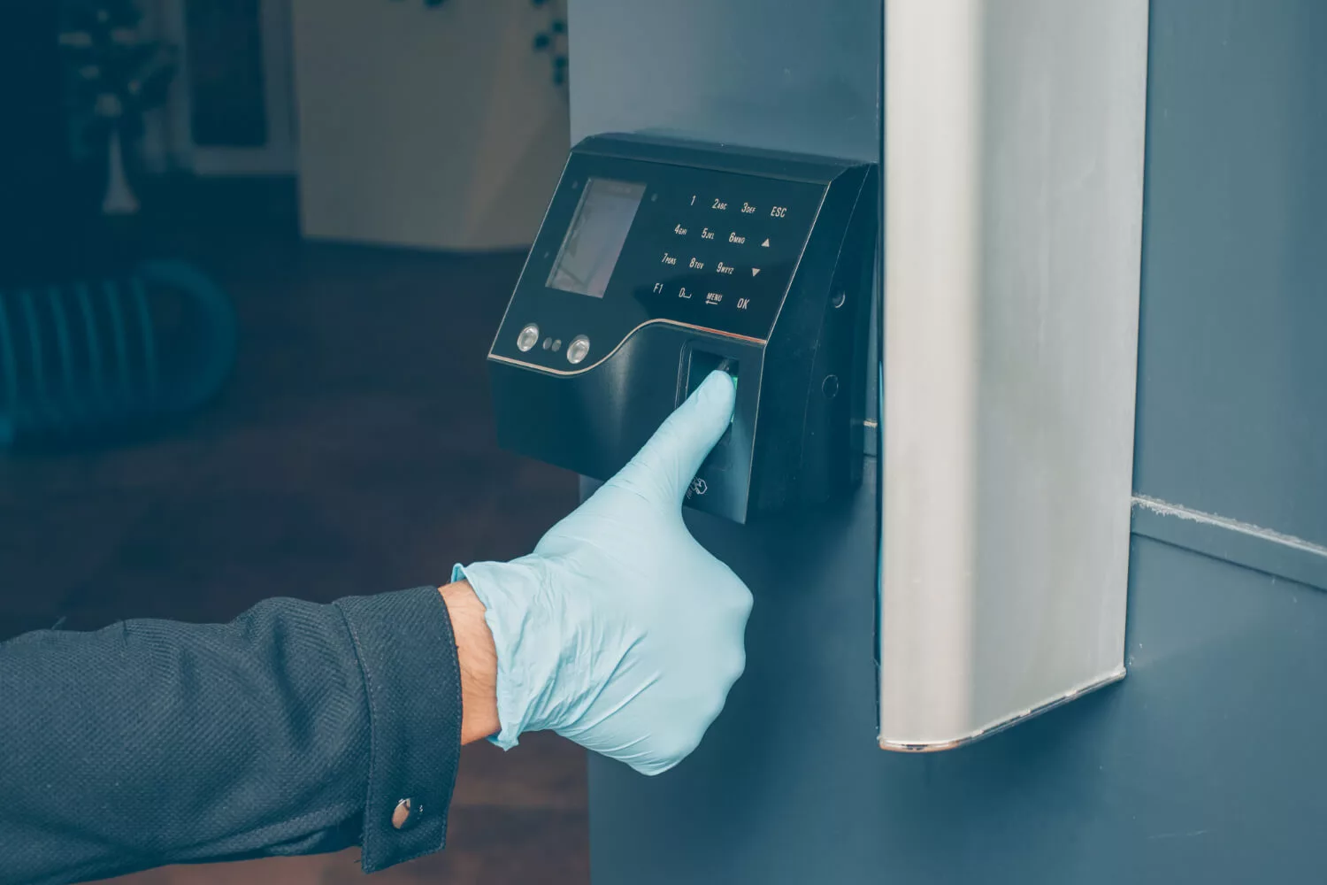 man-getting-intercom-read-his-fingerprint-open-door-with-glove