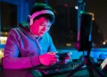 A male cybersport gamer playing online sport leagues multiplayer game via smartphone