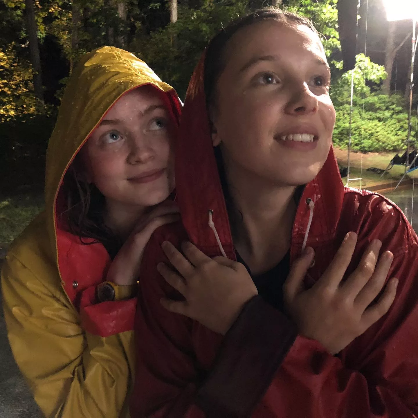 Sadie and Millie Bobby Brown wearing rain coats.