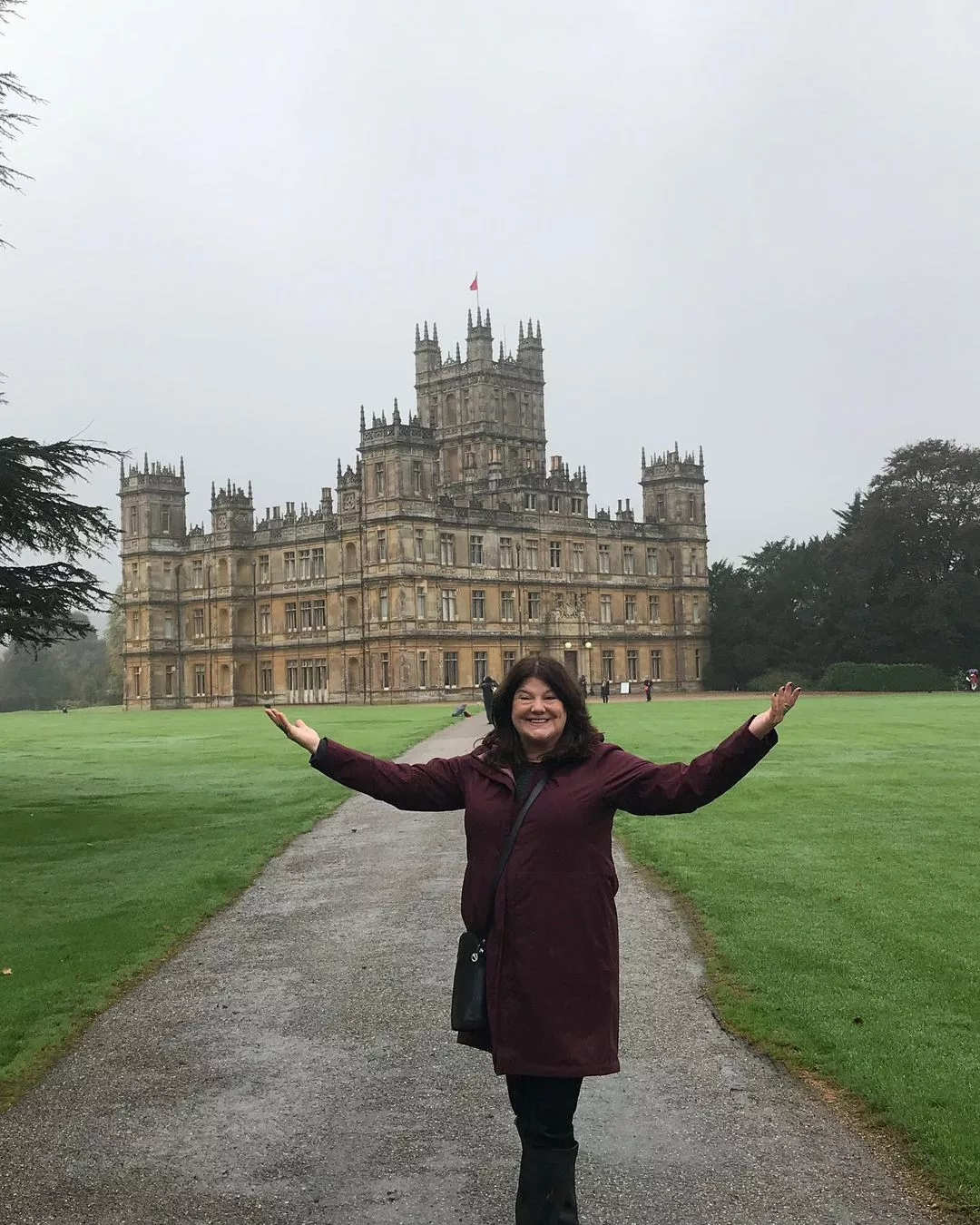 Anne posing in front of a castle. 