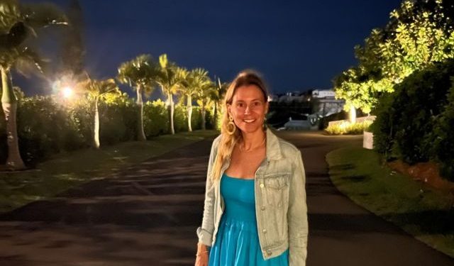 Eric weinberger's wife, Alexandra Kreisler, wearing a blue dress and jacket.